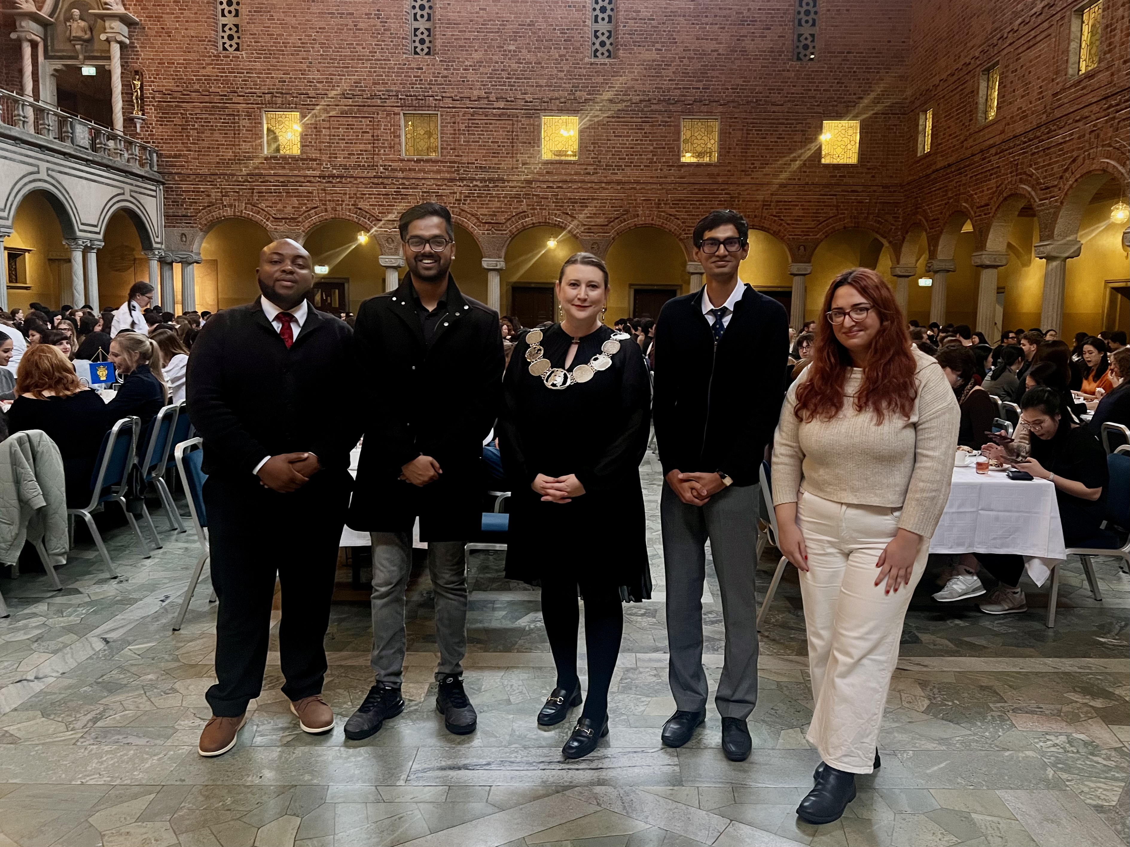 International students and guests posing for a group photo during the welcome reception at Stockholm City Hall.